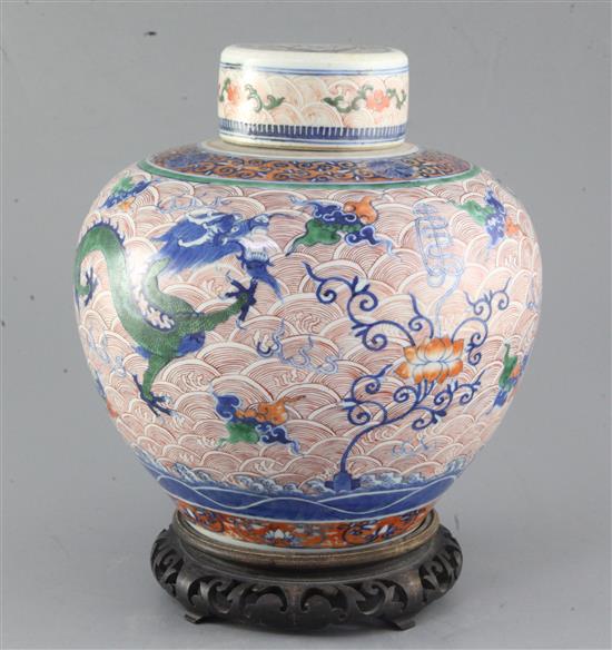 A Chinese doucai dragon ovoid jar and cover, Yongzheng four character mark but 19th century, height 24.5cm excl. wood stand